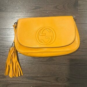 Gucci Orange Clutch with Embossed Logo and Tassel
